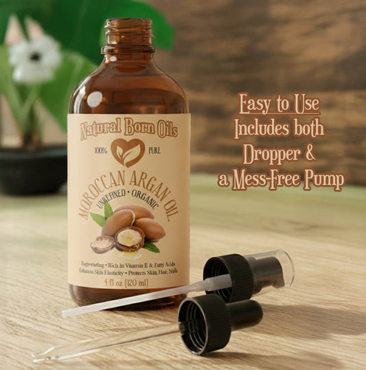 Bottle of Moroccan Argan Oil with dropper and pump on a wooden surface