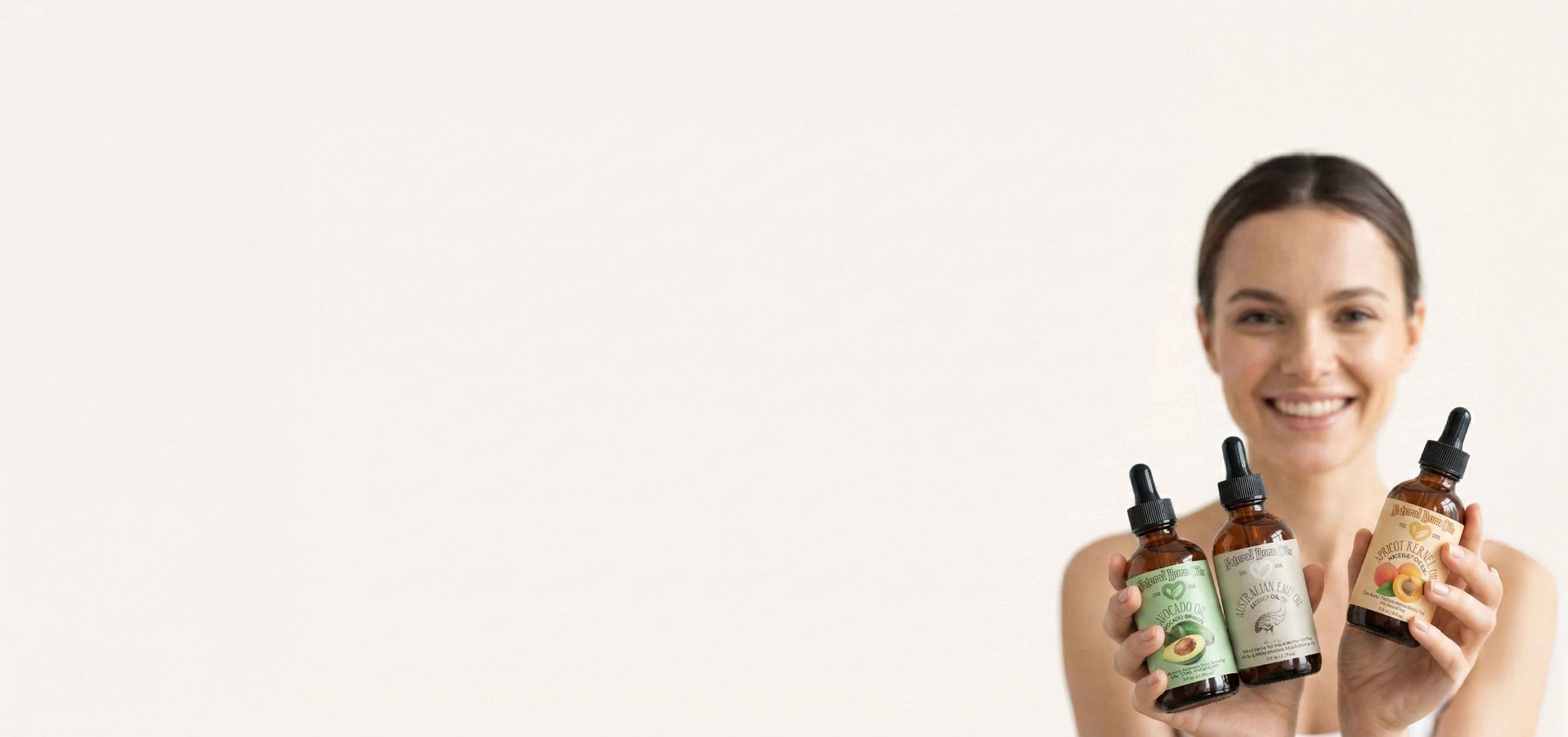 Woman holding three bottles of skincare products against a white background