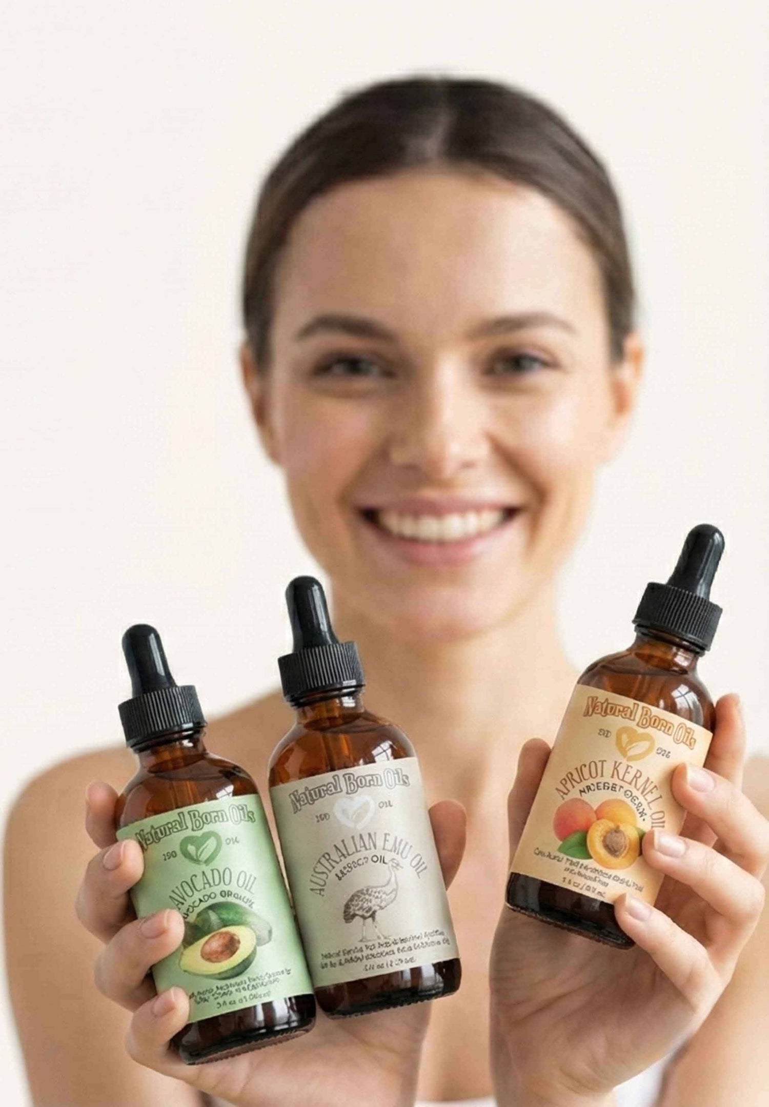 Woman holding three bottles of natural remedies with a plain background