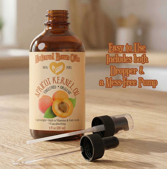 Bottle of apricot kernel oil with a dropper and pump on a wooden surface
