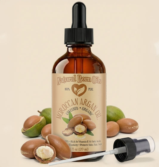 Bottle of Moroccan Argan Oil with dropper and argan nuts on a beige background