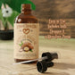 Bottle of Moroccan Argan Oil with dropper and pump on a wooden surface