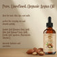 Bottle of organic argan oil with nuts on a wooden surface and beige background