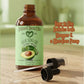 Avocado oil bottle with dropper and pump on a wooden surface