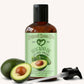 Bottle of Natural Born Oils avocado oil with a pump and two avocados on a white background