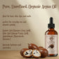 Bottle of Pure, Unrefined, Organic Argan Oil with argan seeds on a beige background