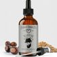 Bottle of Natural Born Oils beard oil with a dropper on a light gray background