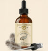 Bottle of Natural Barn Oils with dropper on a beige background