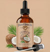 Bottle of Natural Born Oils coconut oil with dropper on a beige background