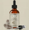 Bottle of Australian Emu Oil with dropper and feather on a beige background
