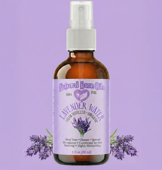 Bottle of Natural Born Oils lavender water spray on a purple background with lavender flowers.