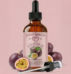 Bottle of Natural Born Oils Maracuja oil with passion fruit on a pink background