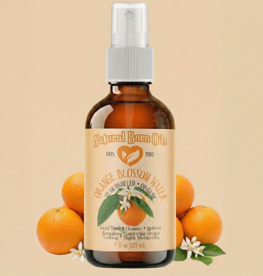 Bottle of Natural Born Oils Orange Blossom Water with oranges and orange blossoms on a beige background