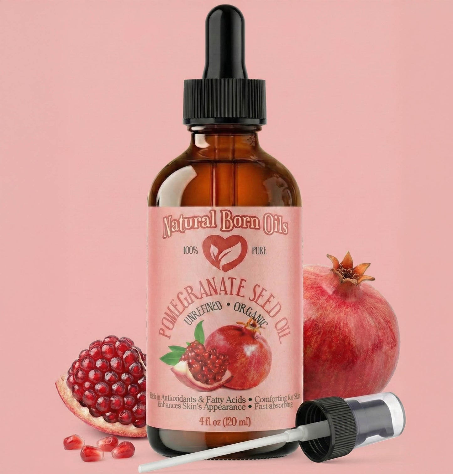 Bottle of Natural Born Oils Pomegranate Seed Oil with pomegranates on a pink background