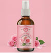 Bottle of Bulgarian Rose Water with pink roses on a pink background