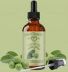 Bottle of Natural Born Oils Tamanu Oil with dropper on a green background