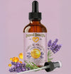 Bottle of Natural Born Oils vitamin E oil with lavender on a purple background