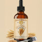 Bottle of Natural Born Oils wheat germ oil with a dropper on a beige background