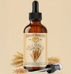 Bottle of Natural Born Oils wheat germ oil with a dropper on a beige background