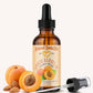 Bottle of apricot kernel oil with a dropper on a white background