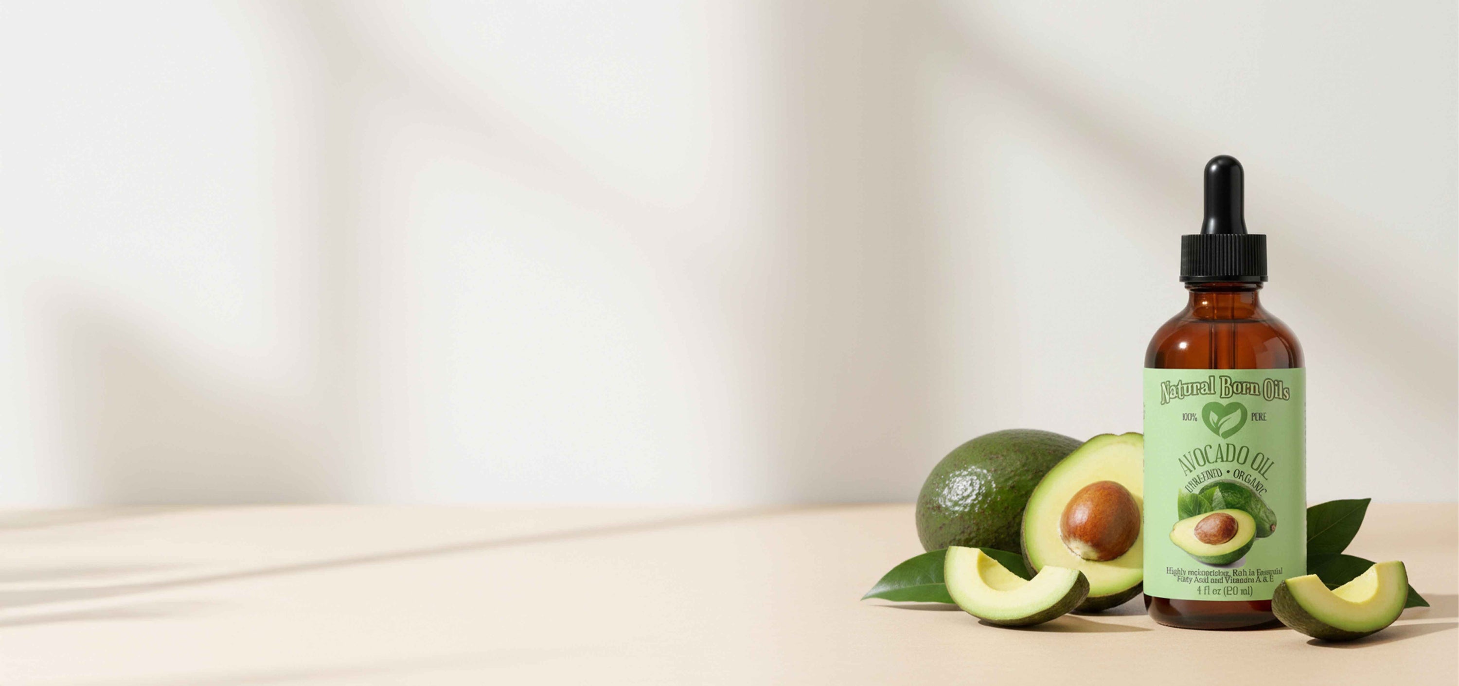 Bottle of avocado oil with avocados on a light background