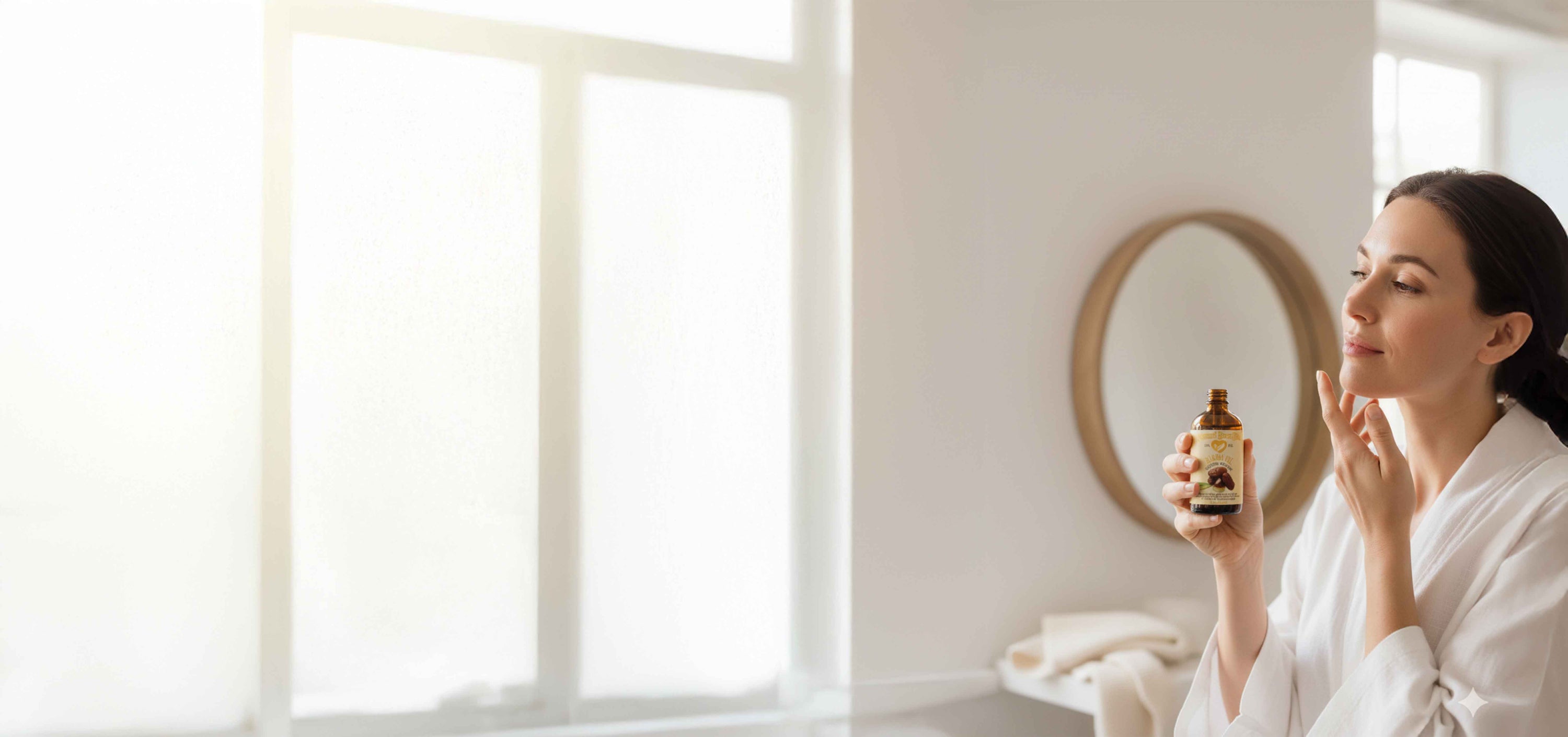 Woman applying skincare product in a bright room with large windows.